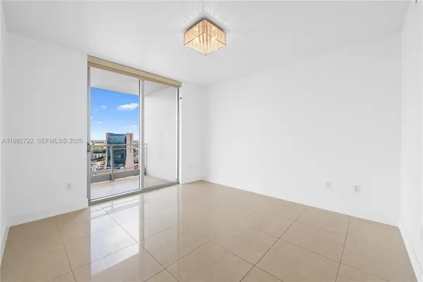 an empty room with entrance and mirror