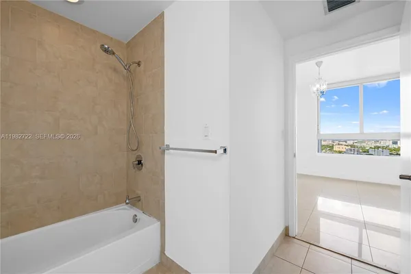a bathroom with a bathtub and a shower