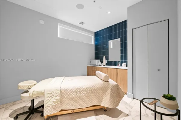 a bedroom with a bed and chair