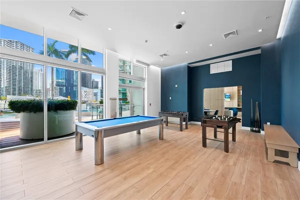 a living room with furniture a table and wooden floor