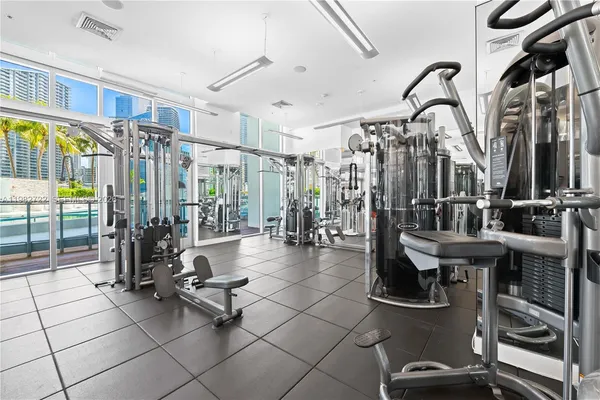 a gym room with lots of gym equipment