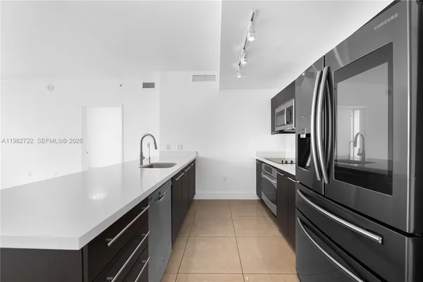 a large kitchen with cabinets and stainless steel appliances