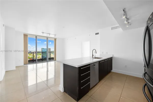 a kitchen with a sink a stove top oven and cabinets