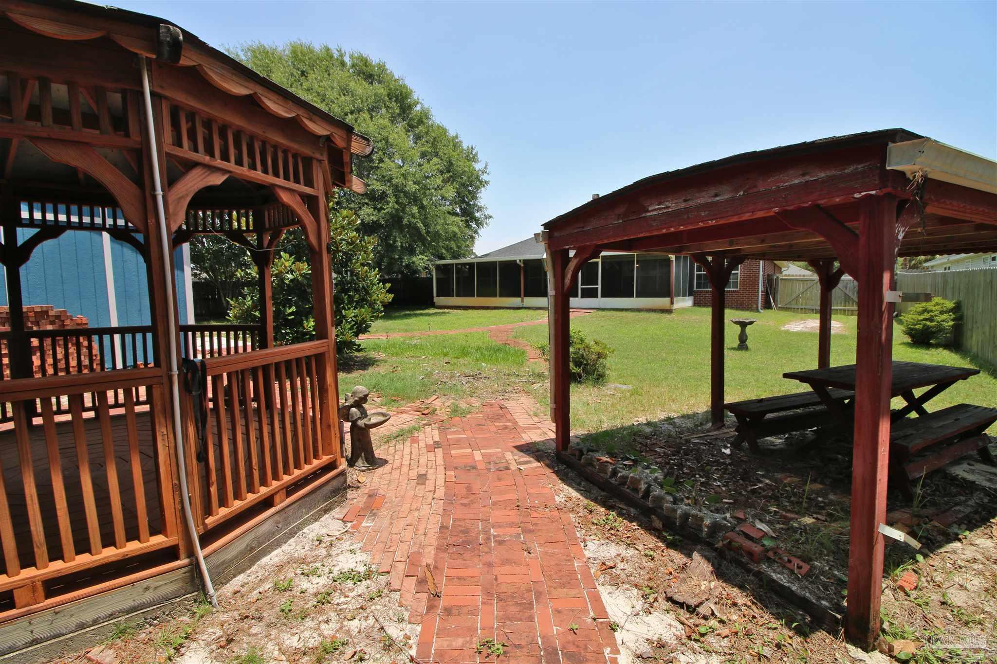 1701 Lighthouse Pointe Drive Gulf Breeze, FL 32563 - Photo 23 of 48 a view of a yard with wooden fence