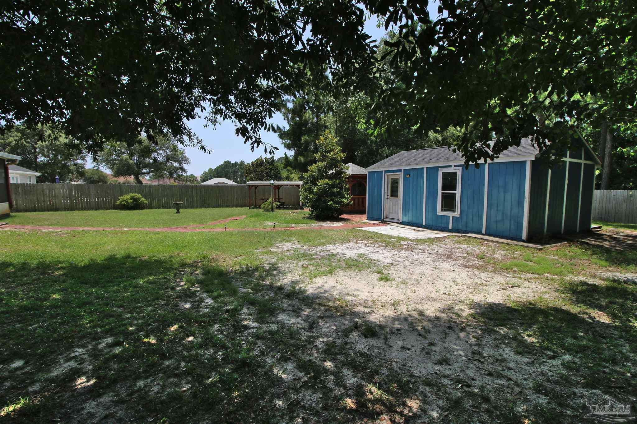 1701 Lighthouse Pointe Drive Gulf Breeze, FL 32563 - Photo 28 of 48 a view of a house with yard and tree s