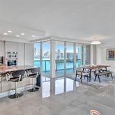 a living room with lots of furniture and a large window