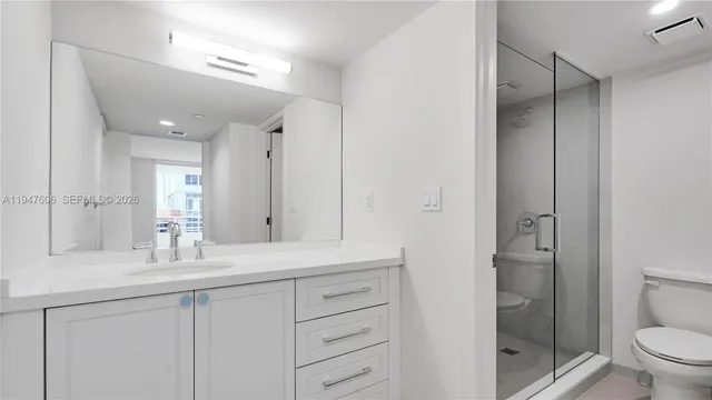 a bathroom with a glass shower door