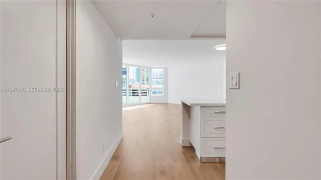 a kitchen with stainless steel appliances a stove a microwave and white cabinets