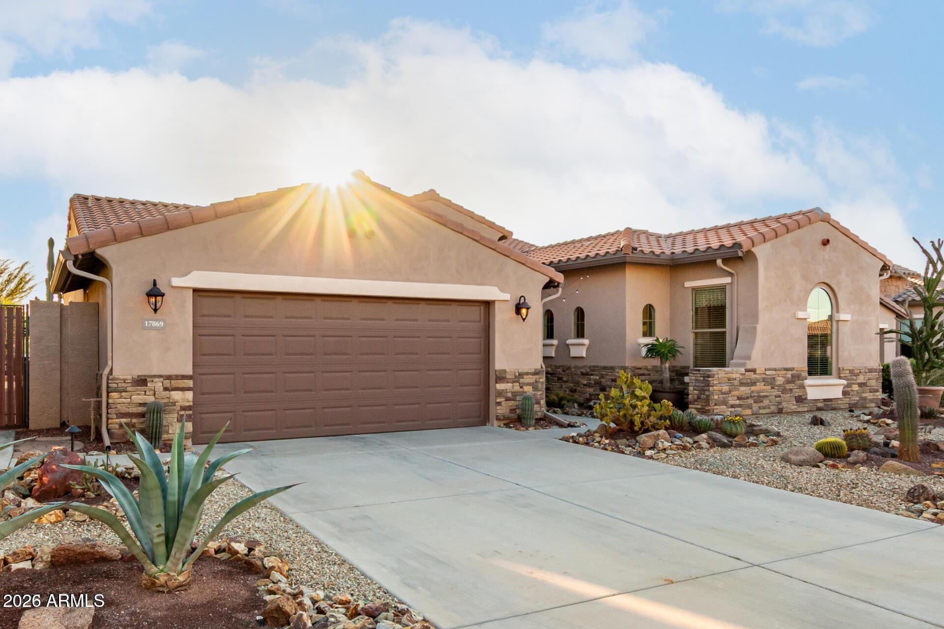 17869 West Verdin Road Goodyear, AZ 85338 - Photo 2 of 39 a view of a house with wooden walls and potted plants