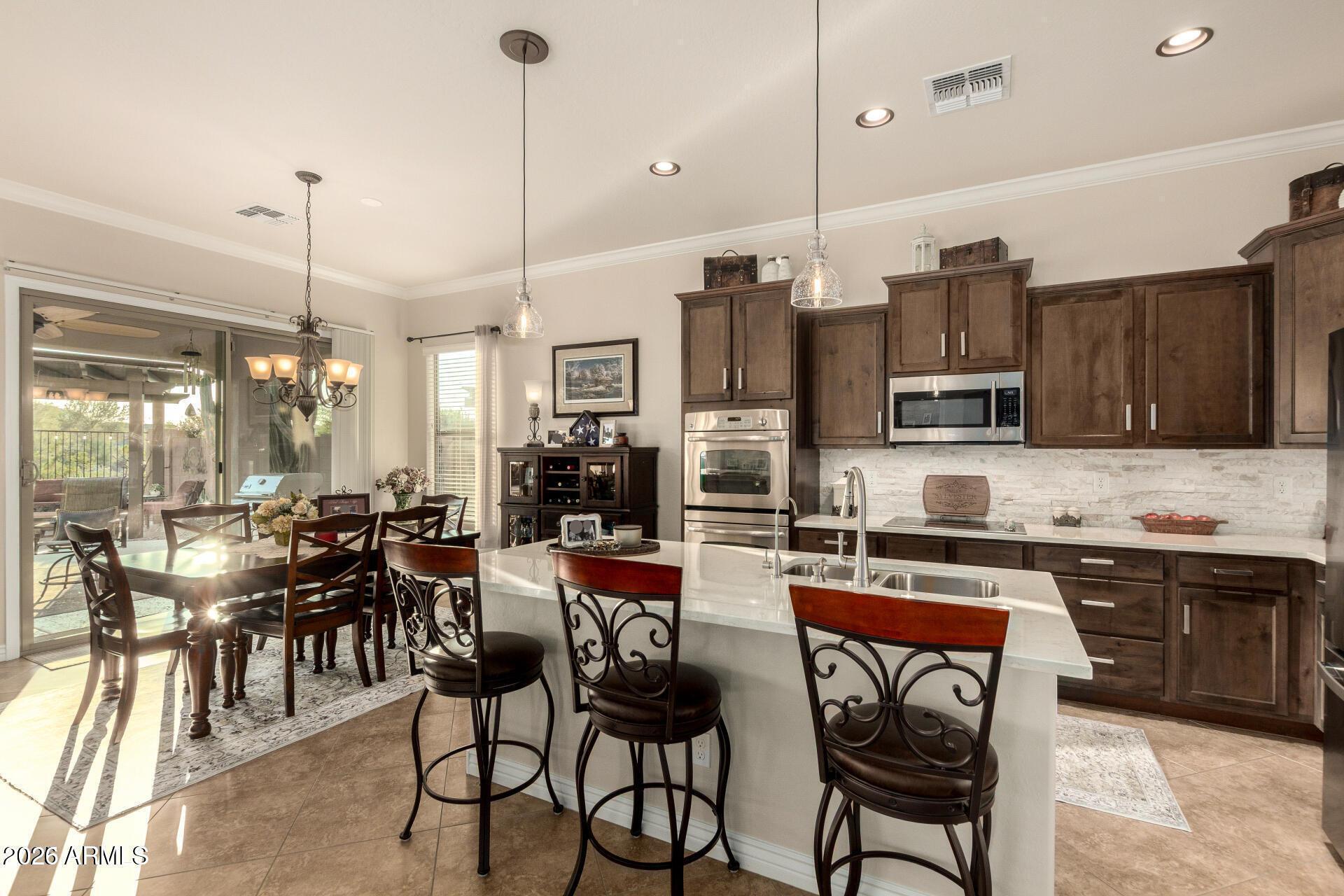 17869 West Verdin Road Goodyear, AZ 85338 - Photo 5 of 39 a kitchen with lots of counter space furniture and appliances