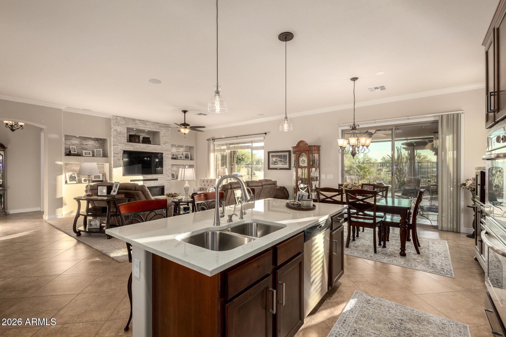 17869 West Verdin Road Goodyear, AZ 85338 - Photo 7 of 39 a kitchen with kitchen island a sink table and chairs