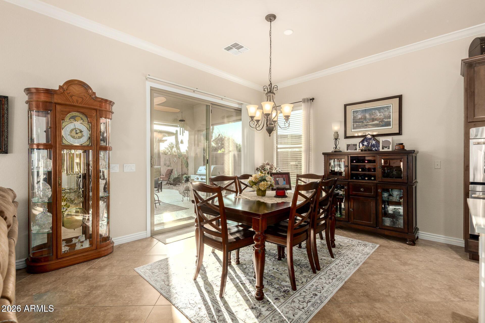 17869 West Verdin Road Goodyear, AZ 85338 - Photo 9 of 39 a view of a dining room with furniture and chandelier
