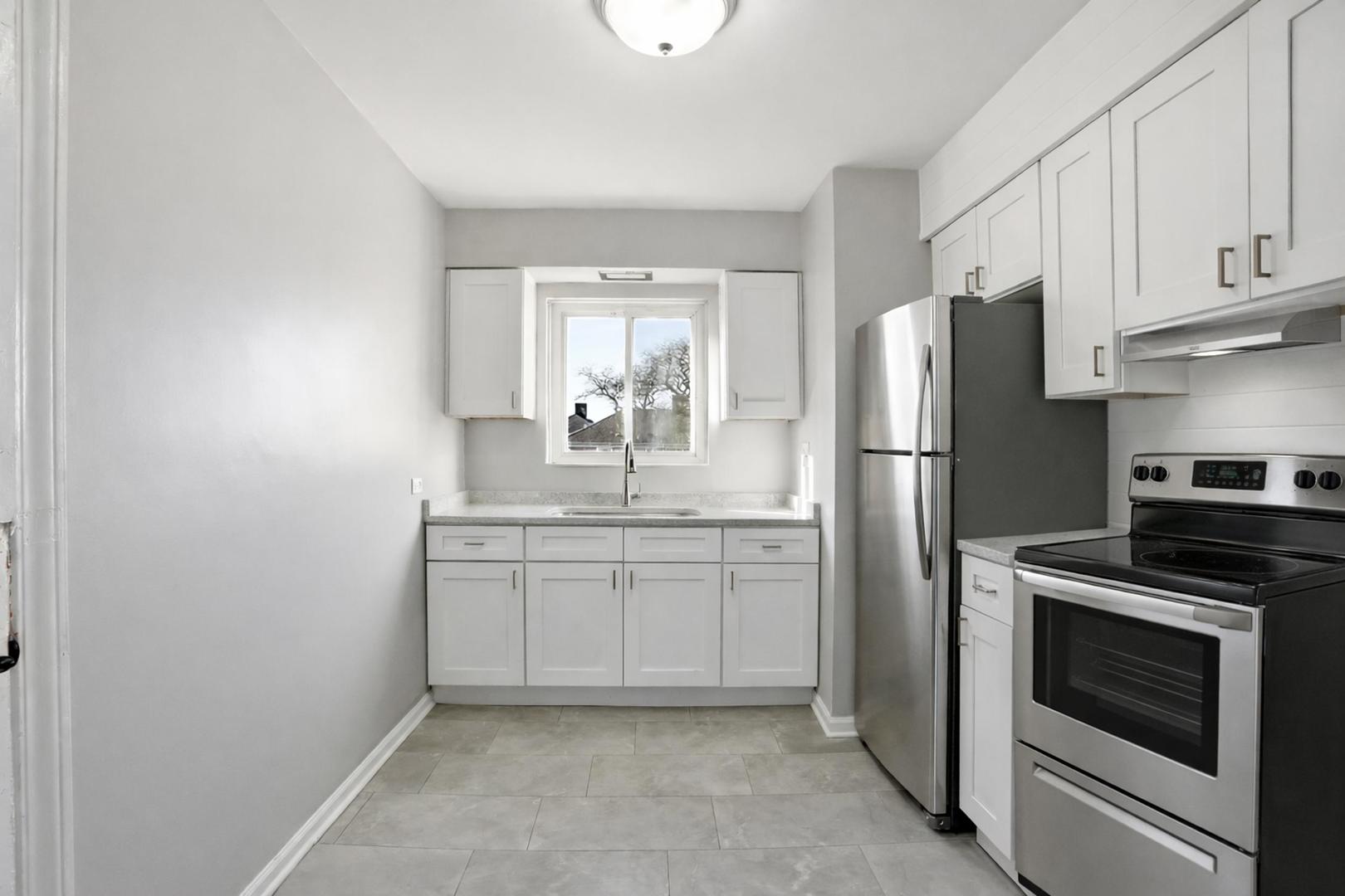 6550 North Ridge Boulevard, Unit 2 Chicago, IL 60626 - Photo 4 of 32 a kitchen with stainless steel appliances granite countertop a refrigerator sink and stove