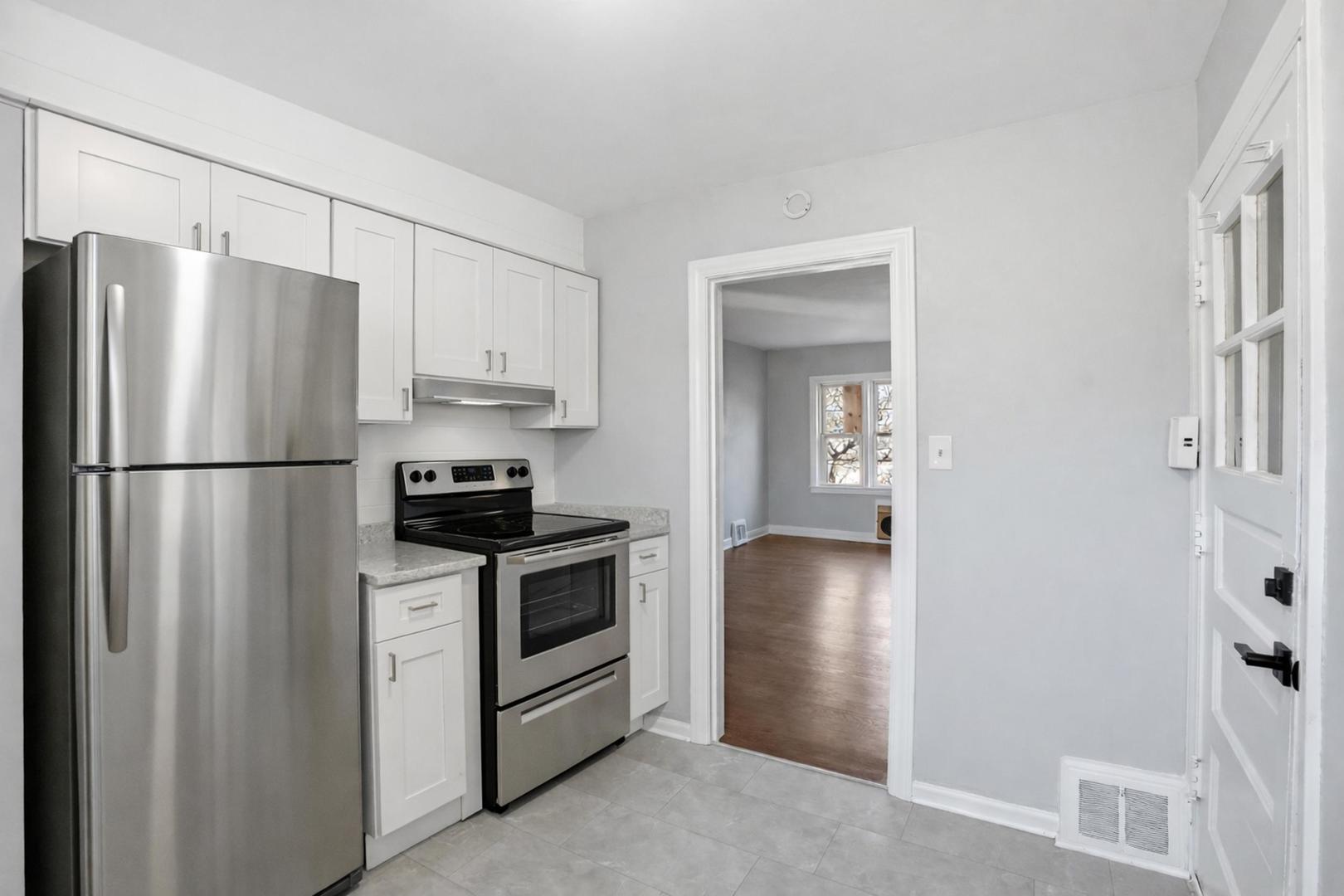 6550 North Ridge Boulevard, Unit 2 Chicago, IL 60626 - Photo 5 of 32 a kitchen with a refrigerator sink and stove