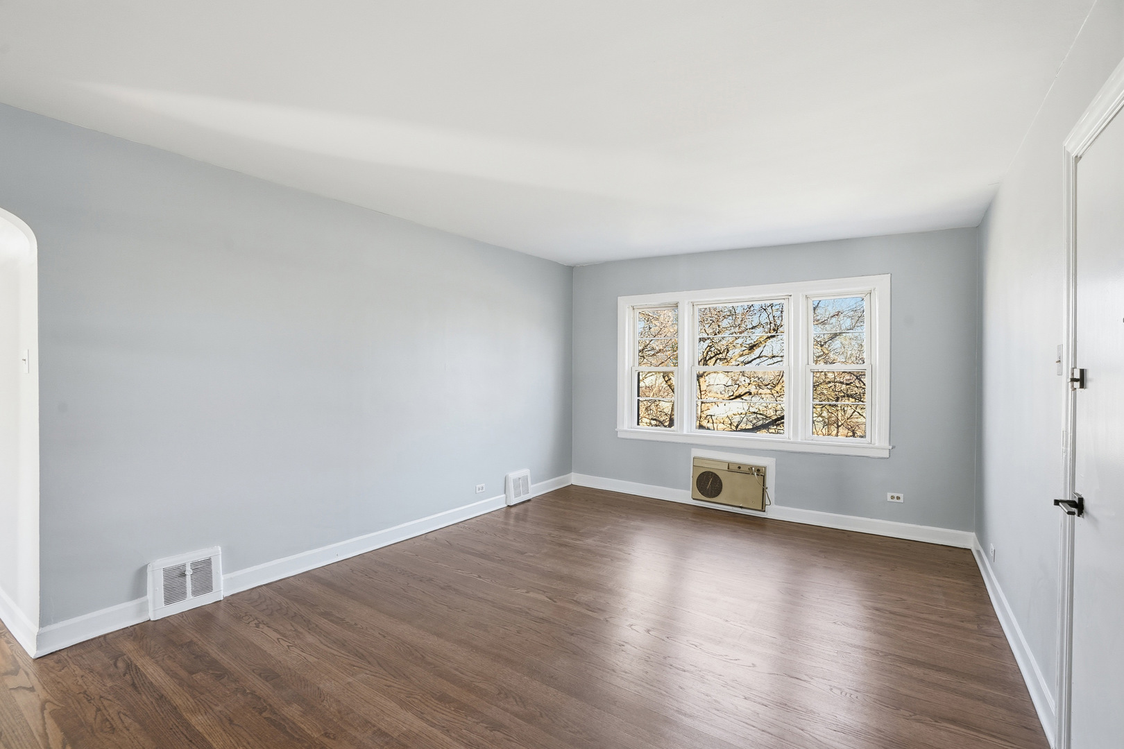 6550 North Ridge Boulevard, Unit 2 Chicago, IL 60626 - Photo 8 of 32 an empty room with wooden floor and windows