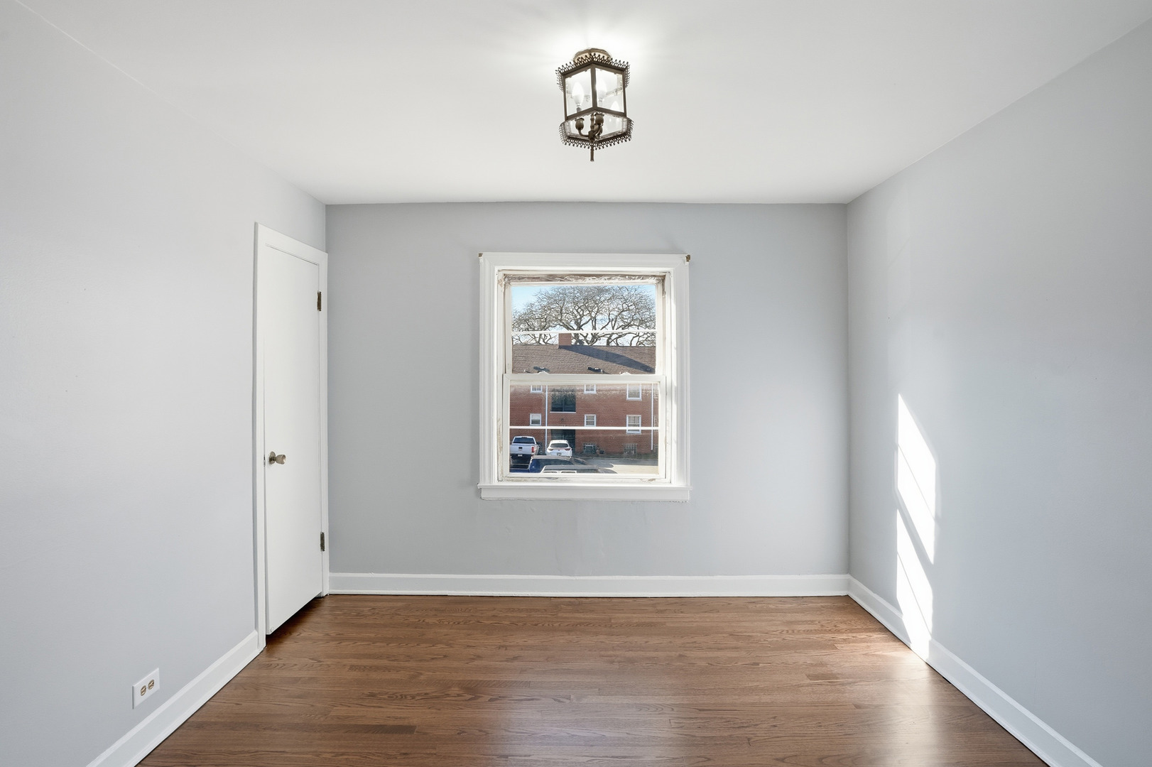 6550 North Ridge Boulevard, Unit 2 Chicago, IL 60626 - Photo 10 of 32 an empty room with wooden floor chandelier and windows