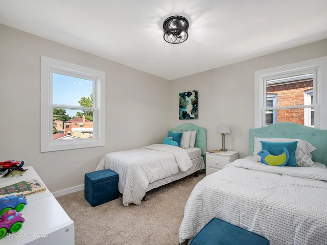 a bedroom with two beds and a table