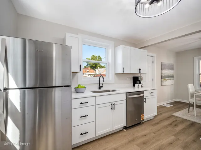 a kitchen with stainless steel appliances a refrigerator sink and stove