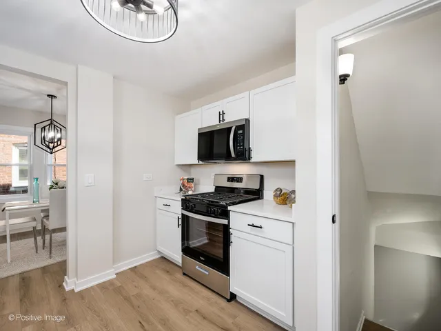 a kitchen with a sink and a stove top oven
