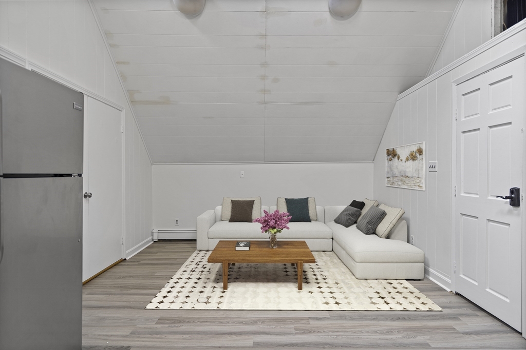 155 5th Street, Unit 3 Cambridge, MA 02141 - Photo 2 of 9 a bedroom with a bed and a couch