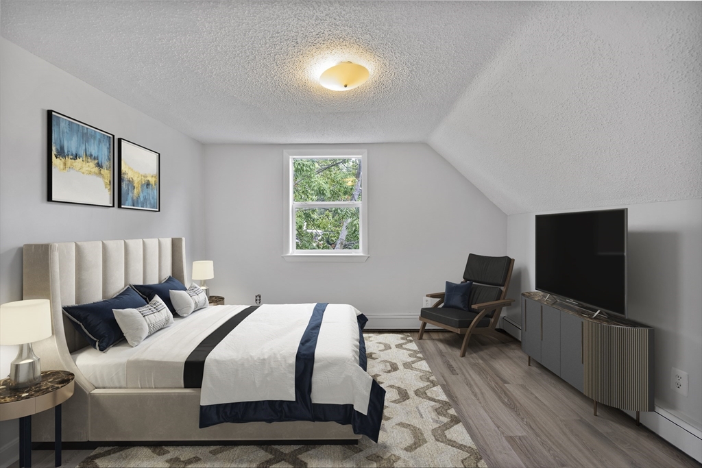 155 5th Street, Unit 3 Cambridge, MA 02141 - Photo 8 of 9 a bedroom with a bed and a flat screen tv