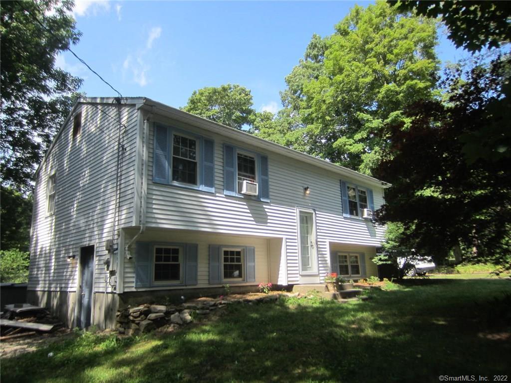 124 Sawmill Hill Road Sterling, CT 06377 - Photo 1 of 1 a front view of a house with a yard