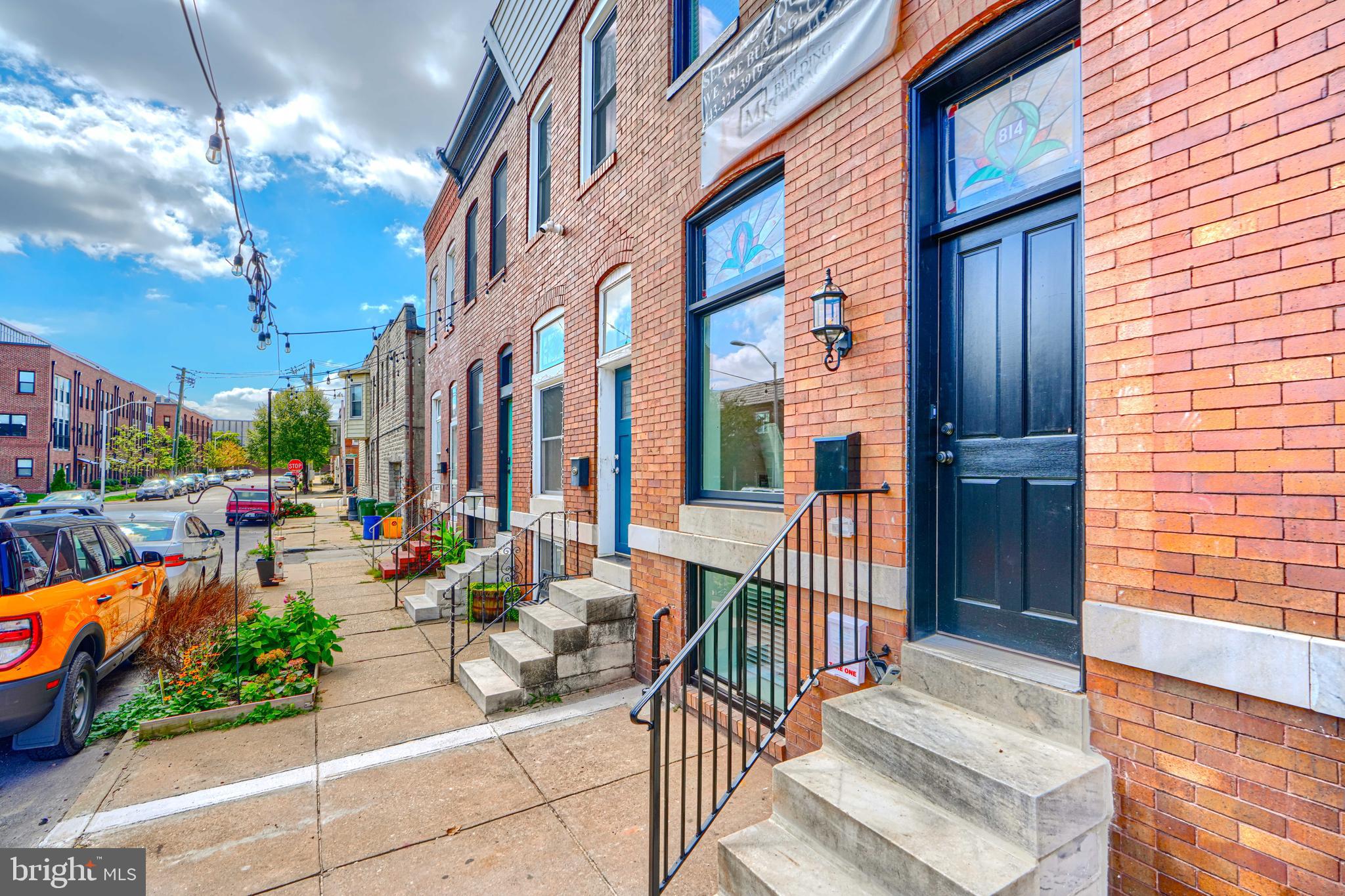 a view of a patio with couches table and chairs and potted plants