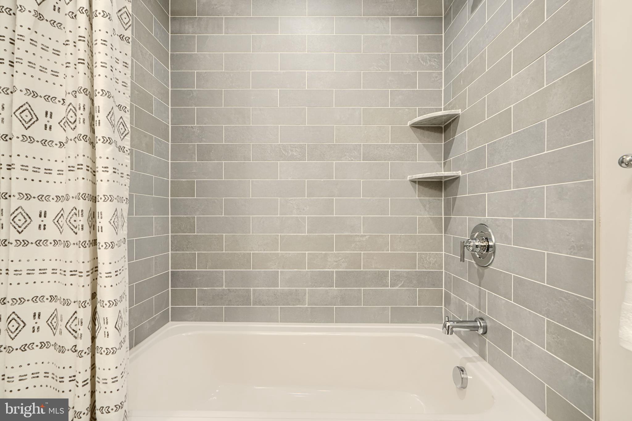 814 Grundy Street Baltimore, MD 21224 - Photo 22 of 31 a bathroom with a shower and a bathtub