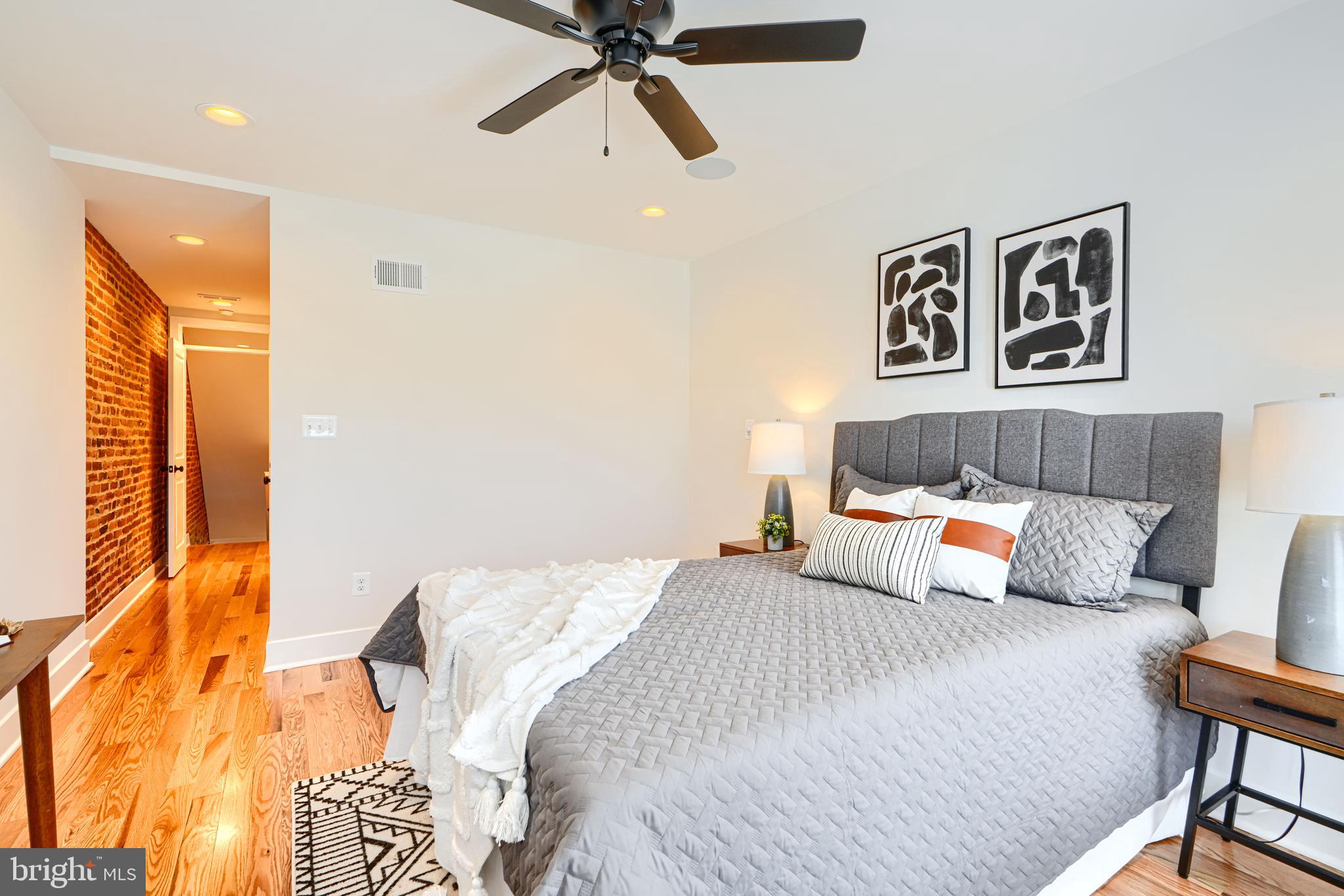 814 Grundy Street Baltimore, MD 21224 - Photo 25 of 31 a bedroom with a bed and wooden floor