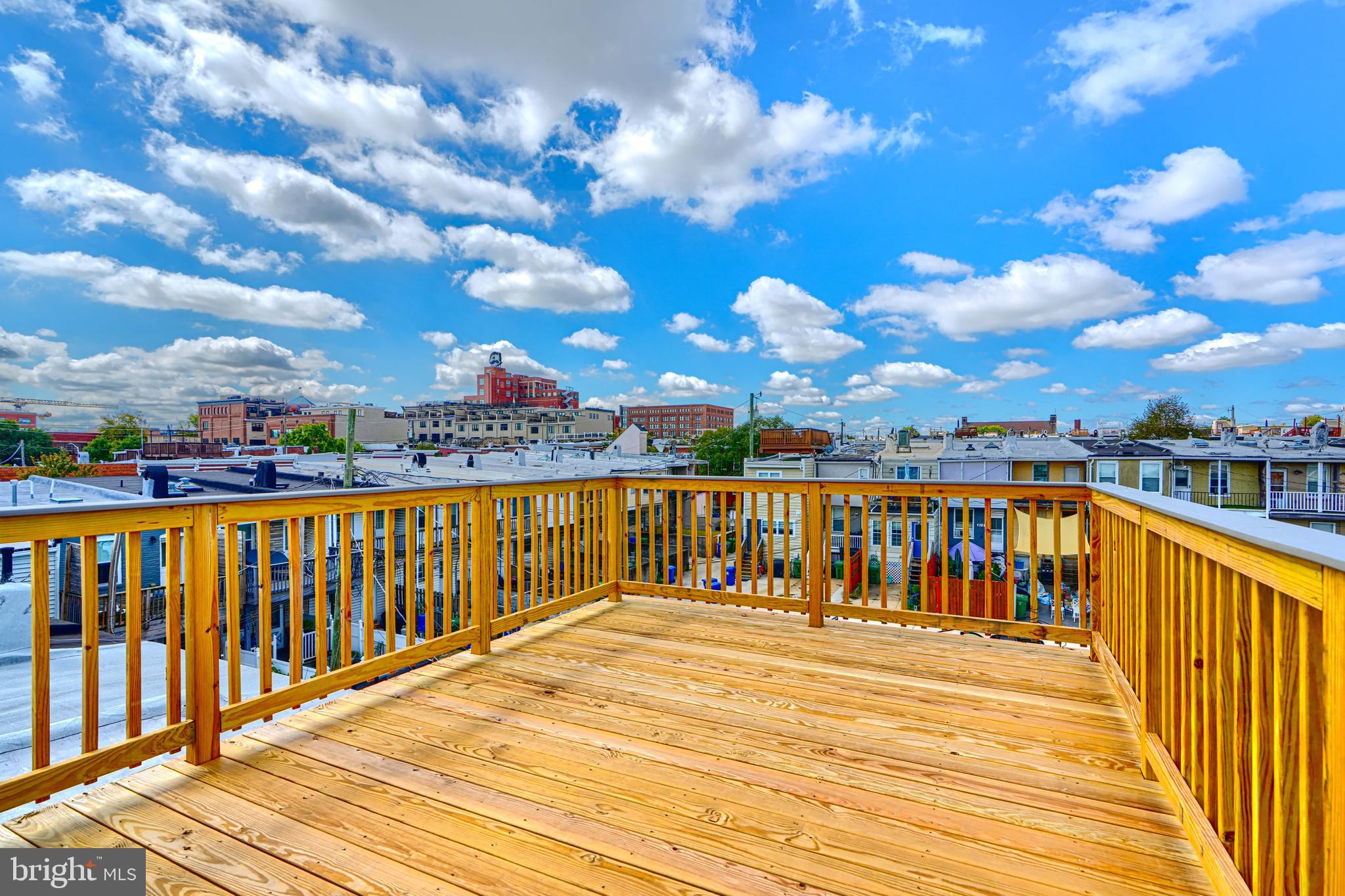814 Grundy Street Baltimore, MD 21224 - Photo 29 of 31 a view of a balcony with wooden chairs