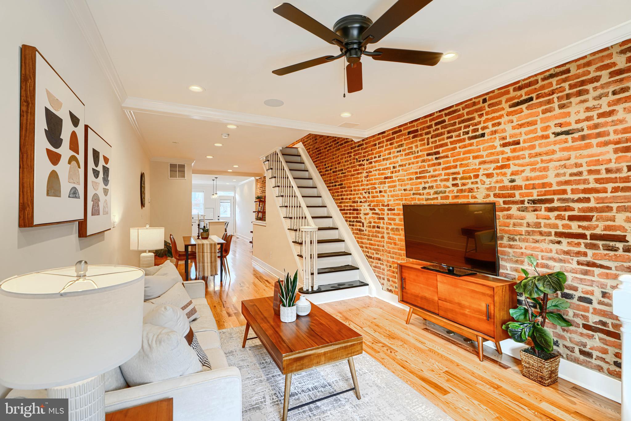 814 Grundy Street Baltimore, MD 21224 - Photo 4 of 31 a living room with furniture a flat screen tv and a fireplace