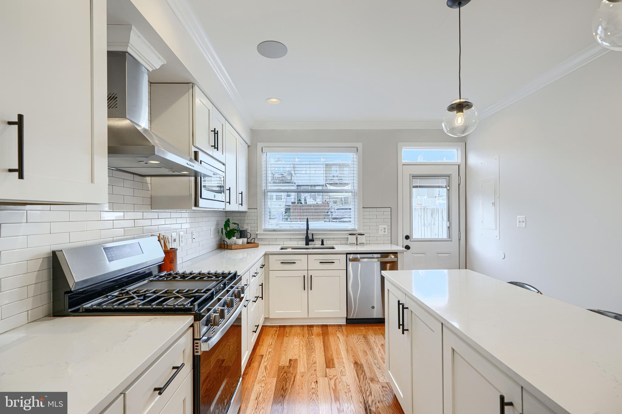 814 Grundy Street Baltimore, MD 21224 - Photo 10 of 31 a kitchen with a stove a sink a refrigerator and cabinets