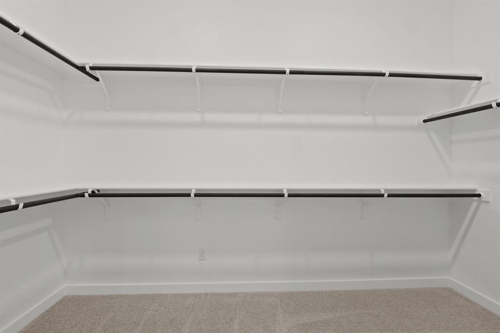 8208 Coastal Lane Pilot Point, TX 76258 - Photo 13 of 17 Primary Closet in the Pecan II home plan by Trophy Signature Homes – REPRESENTATIVE PHOTO