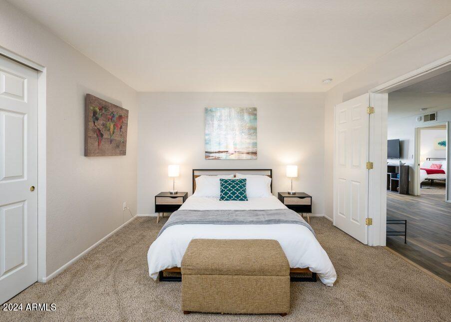 4303 East Cactus Road, Unit 235 Phoenix, AZ 85032 - Photo 17 of 29 a bedroom with a bed and a view of bedroom