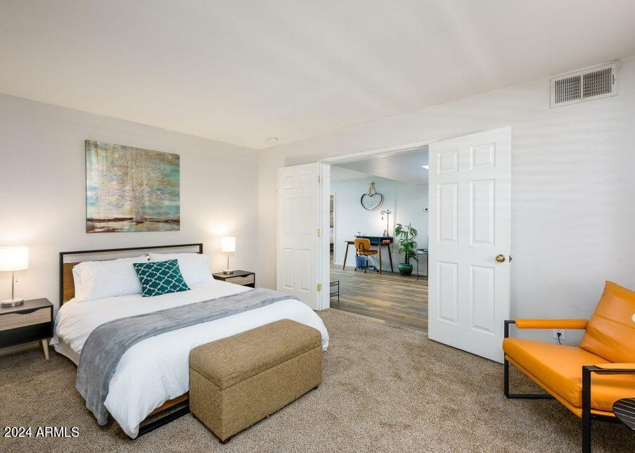 4303 East Cactus Road, Unit 235 Phoenix, AZ 85032 - Photo 18 of 29 a bedroom with a bed and a couch