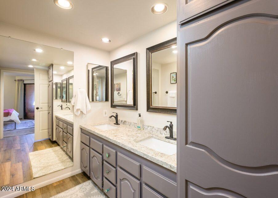 4303 East Cactus Road, Unit 235 Phoenix, AZ 85032 - Photo 19 of 29 a spacious bathroom with a double vanity sink a mirror and a bathtub