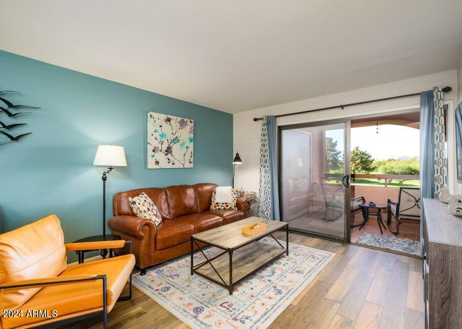 4303 East Cactus Road, Unit 235 Phoenix, AZ 85032 - Photo 2 of 29 a living room with furniture and a large window