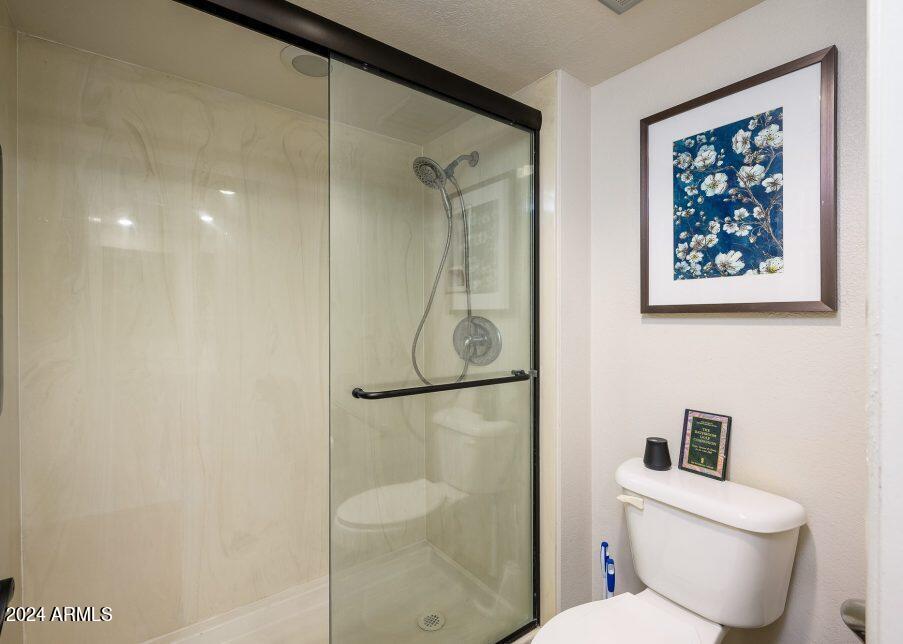 4303 East Cactus Road, Unit 235 Phoenix, AZ 85032 - Photo 23 of 29 a white toilet sitting next to a bathroom sink