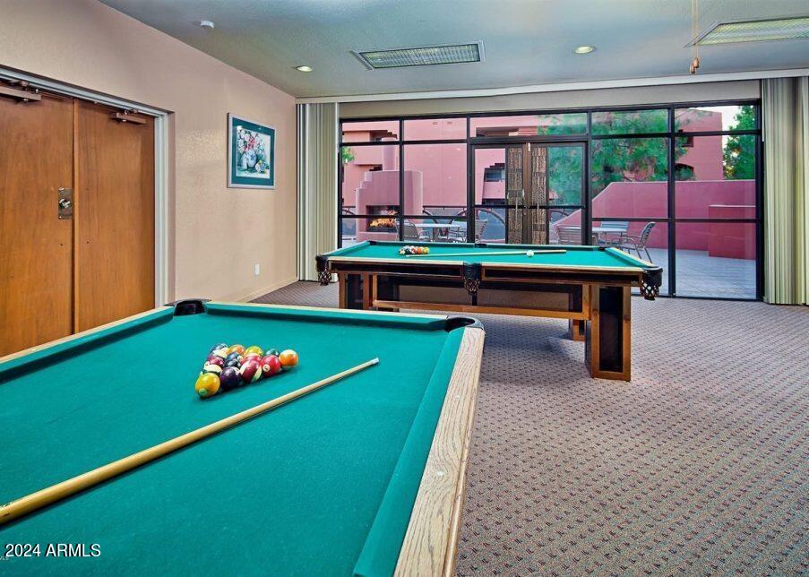 4303 East Cactus Road, Unit 235 Phoenix, AZ 85032 - Photo 26 of 29 a room with pool table and windows