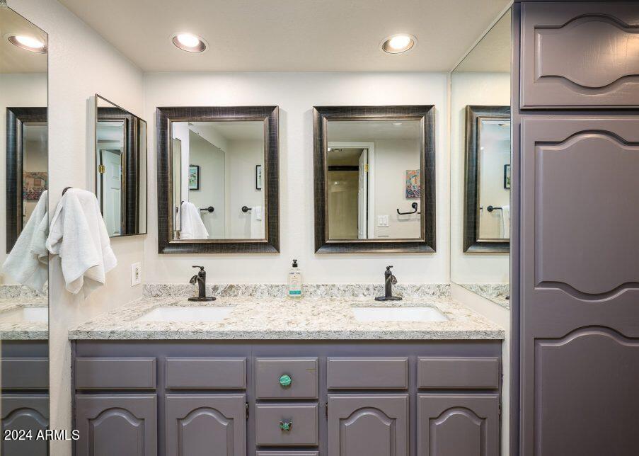 4303 East Cactus Road, Unit 235 Phoenix, AZ 85032 - Photo 7 of 29 a bathroom with a granite countertop sink vanity and mirror