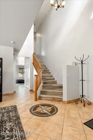 a view of a hallway with dining room and stairs