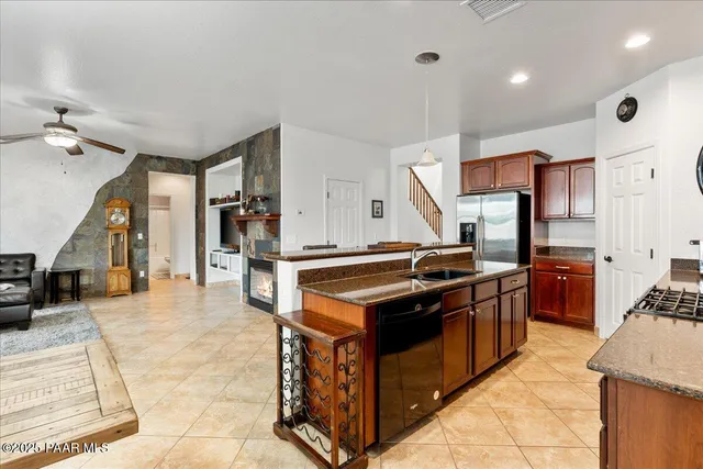 a kitchen with stainless steel appliances granite countertop a stove and a sink