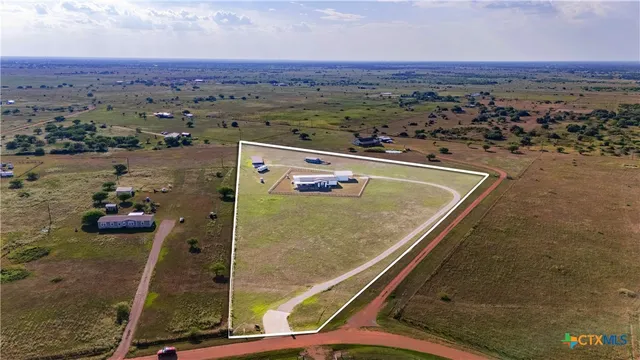 an aerial view of a residential houses with outdoor space