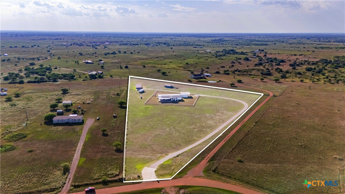 an aerial view of a residential houses with outdoor space