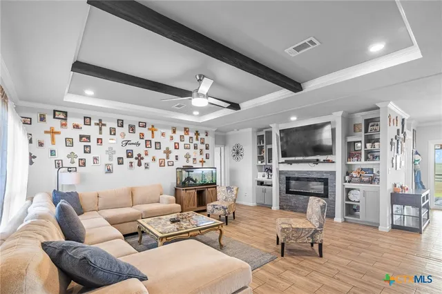 a living room with furniture fireplace and a flat screen tv