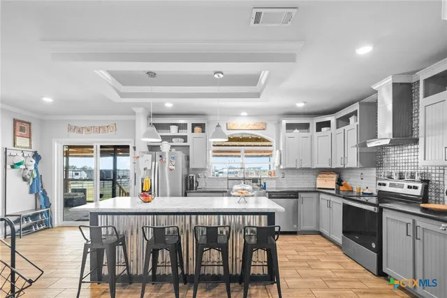 a kitchen with a table chairs sink and cabinets