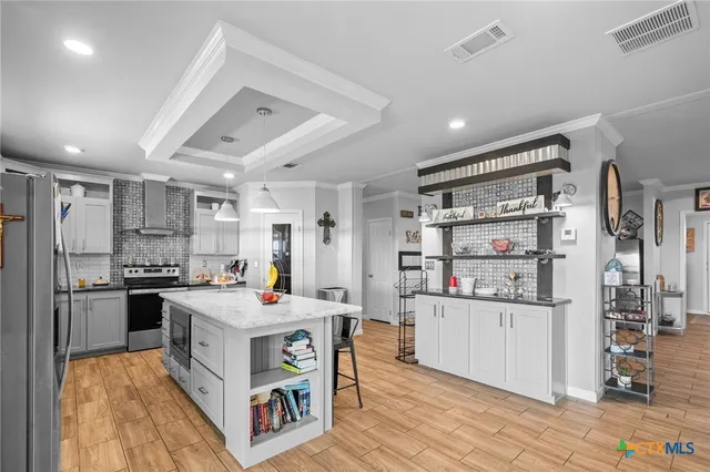 a open kitchen with stainless steel appliances granite countertop a stove oven and a refrigerator