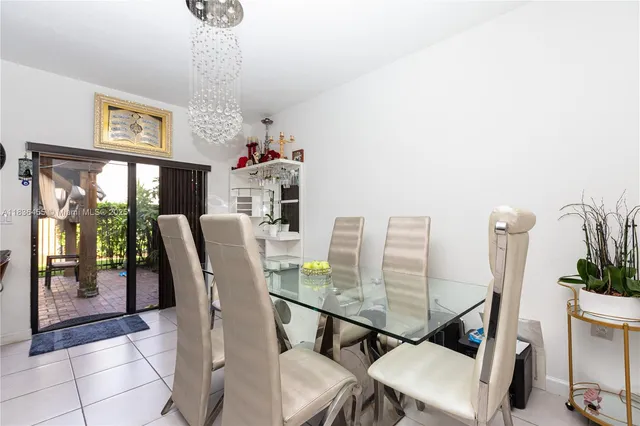 a view of a dining room with furniture a chandelier and wooden floor