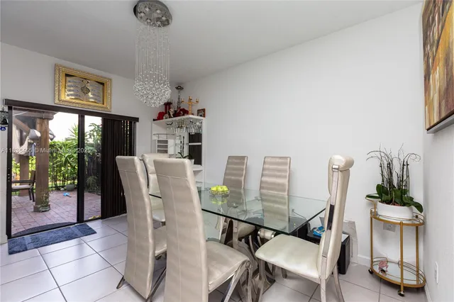a dining room with furniture and a floor to ceiling window