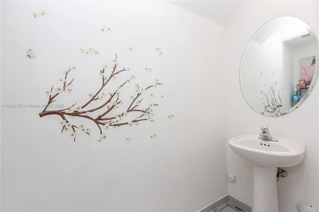 a bathroom with a sink and mirror